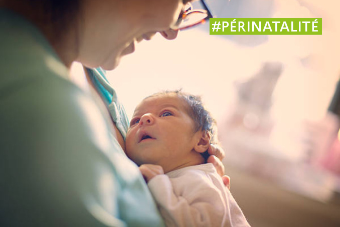 photo d'un nourrisson dans les bras de sa maman à la maternité